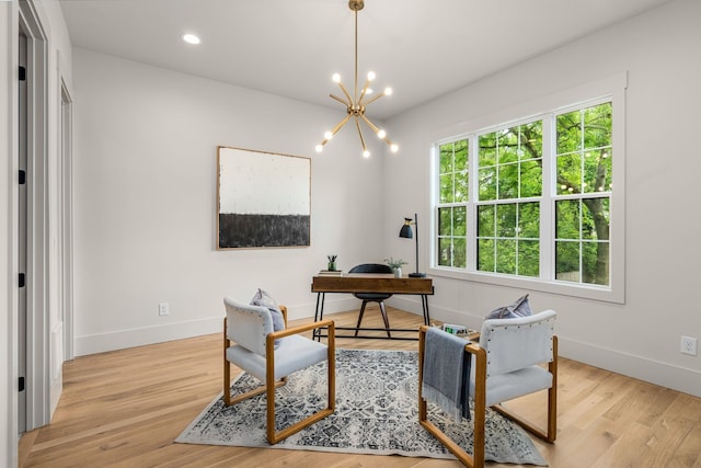 office space featuring an inviting chandelier and light wood-type flooring