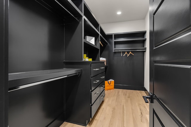 walk in closet featuring light hardwood / wood-style flooring