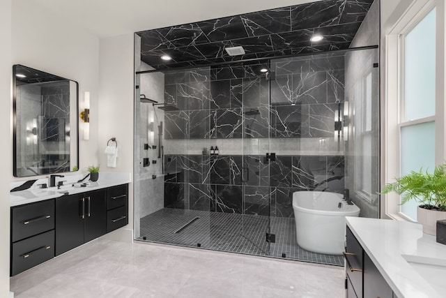 bathroom featuring separate shower and tub, vanity, and tile walls