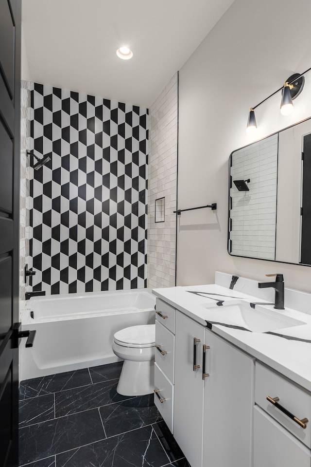 full bathroom featuring tiled shower / bath combo, vanity, and toilet