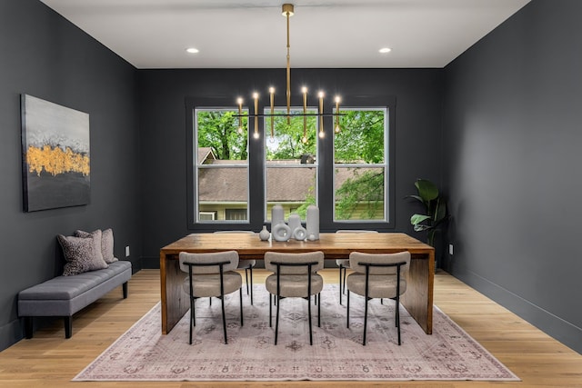 dining space featuring a notable chandelier and light wood-type flooring