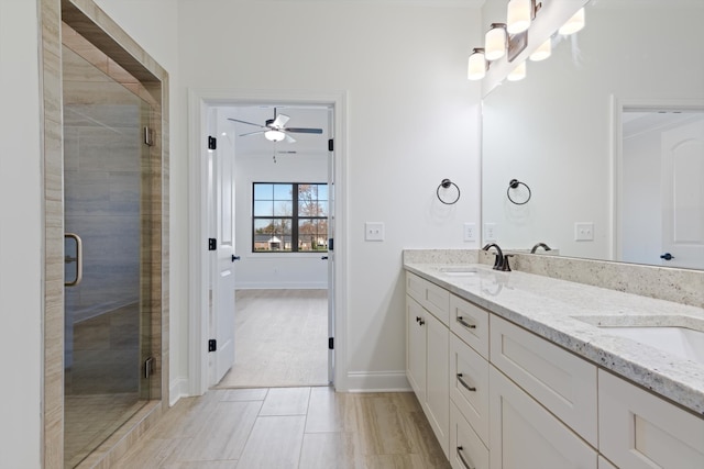 bathroom with ceiling fan, vanity, and an enclosed shower