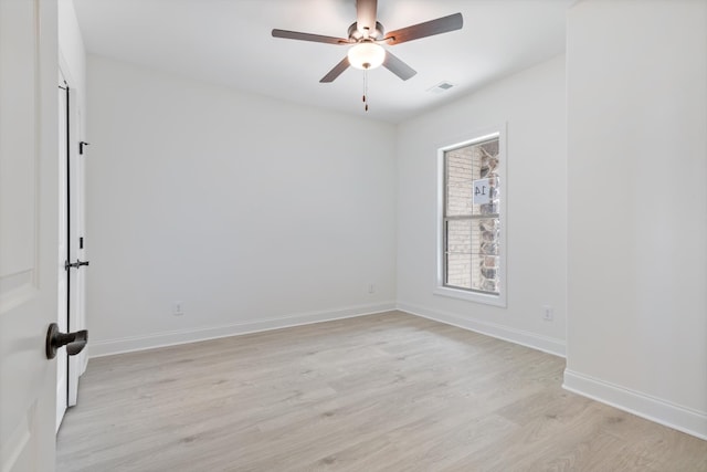 spare room featuring light hardwood / wood-style floors and ceiling fan