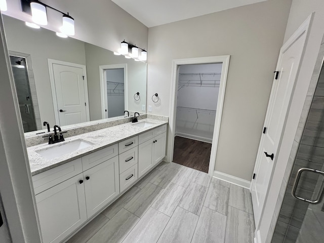 bathroom featuring an enclosed shower and vanity