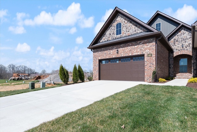 view of front of house with a garage and a front lawn