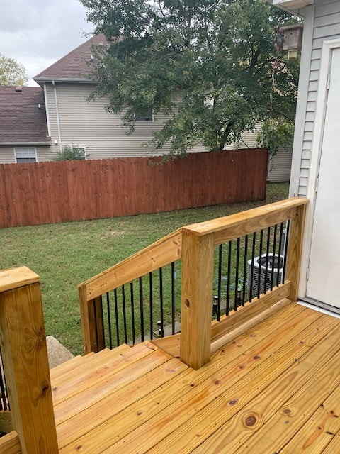 wooden terrace with a lawn