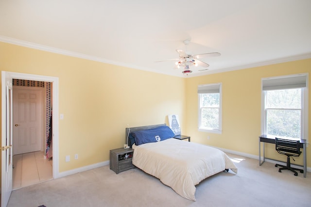 bedroom featuring crown molding, light colored carpet, and ceiling fan