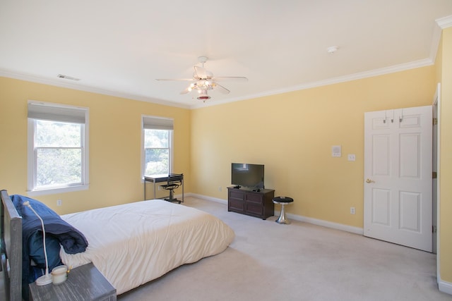 bedroom featuring ornamental molding, light colored carpet, and ceiling fan