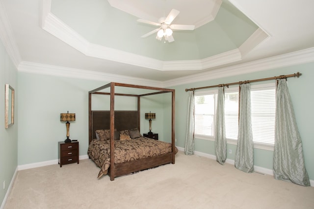 bedroom with light carpet, ornamental molding, a raised ceiling, and ceiling fan