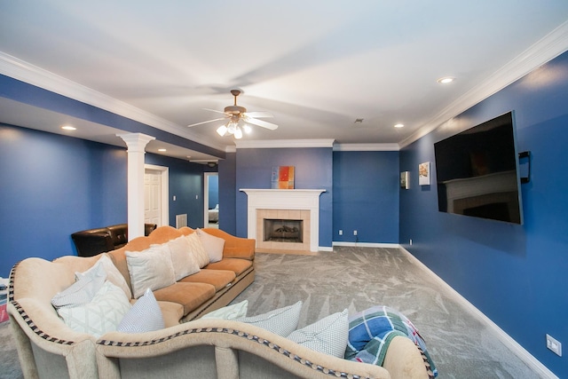 living room with carpet floors, ceiling fan, ornamental molding, and a tiled fireplace