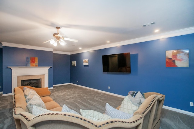 carpeted living room featuring ceiling fan, ornamental molding, and a tile fireplace