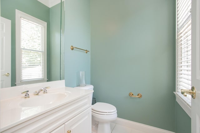 bathroom with vanity, tile patterned flooring, and toilet