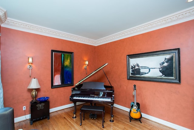 misc room with wood-type flooring and crown molding