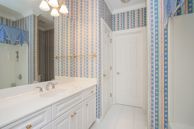 bathroom with ornamental molding, tile patterned floors, and vanity