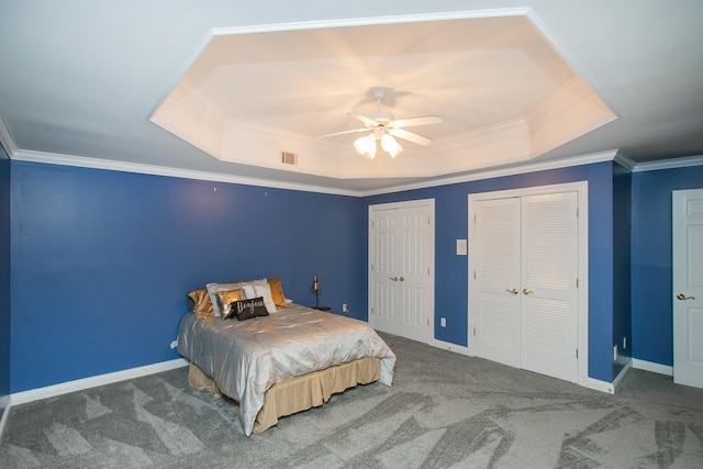 bedroom with a raised ceiling, ornamental molding, carpet, and ceiling fan