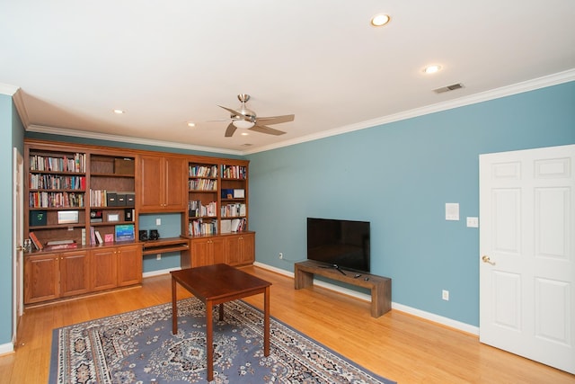 office space featuring crown molding, ceiling fan, and light hardwood / wood-style flooring