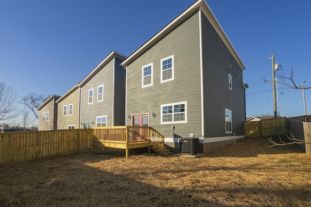 rear view of house featuring central AC unit