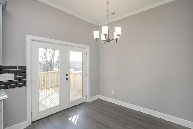 entryway with a notable chandelier, french doors, dark hardwood / wood-style flooring, and ornamental molding