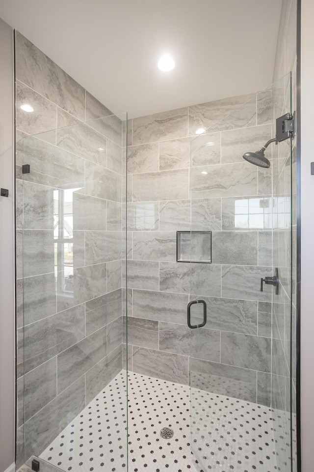 bathroom featuring a shower with shower door