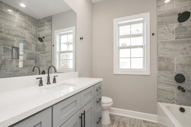 full bathroom with a healthy amount of sunlight, toilet, vanity, and tiled shower / bath combo