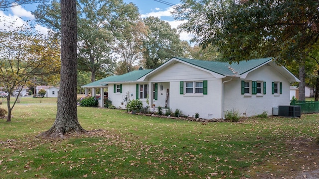 ranch-style house with central air condition unit and a front yard