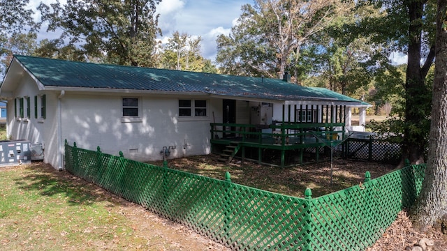 back of property featuring a wooden deck