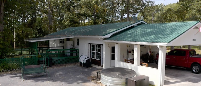 back of house with a carport