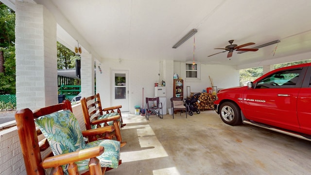 garage with a carport and ceiling fan