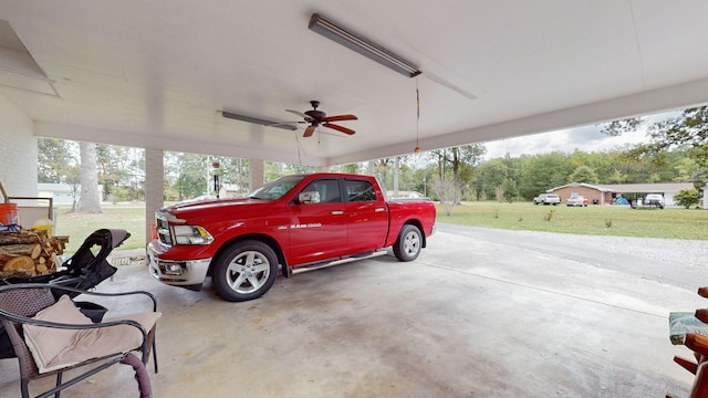 garage with a lawn and ceiling fan