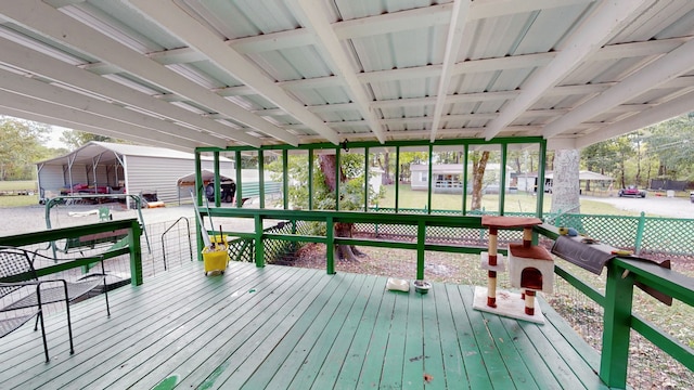 wooden terrace featuring a lawn