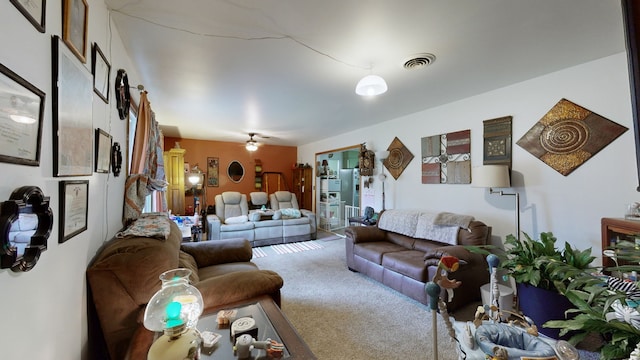 living room featuring carpet flooring and ceiling fan