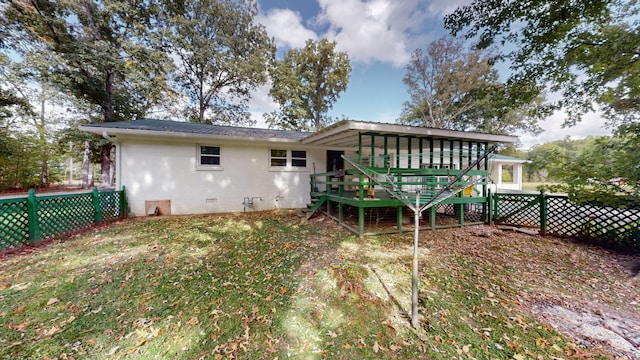 back of property featuring a wooden deck