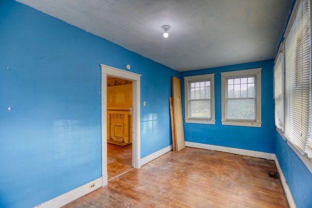 unfurnished room featuring baseboards and wood finished floors