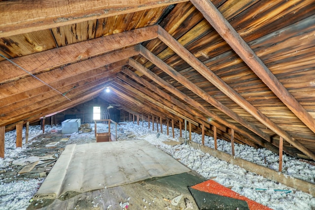 unfinished attic featuring an upstairs landing