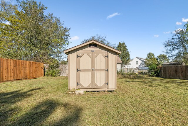 view of outdoor structure featuring a lawn