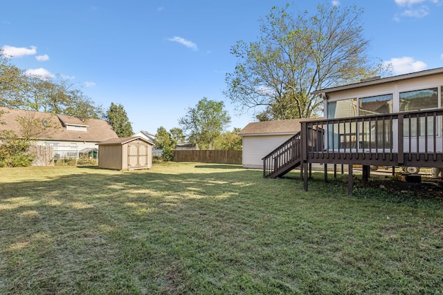 view of yard with a wooden deck and a storage unit