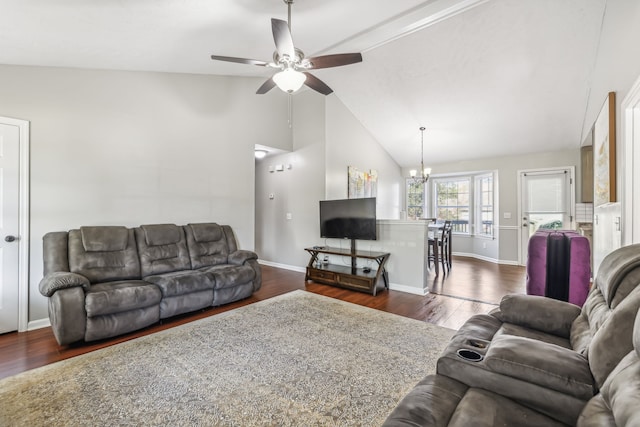 living room featuring ceiling fan with notable chandelier, lofted ceiling, and dark hardwood / wood-style flooring