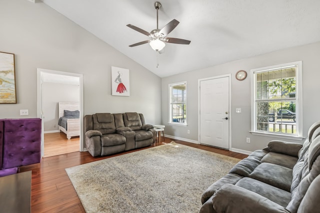 living room with dark wood-type flooring, high vaulted ceiling, and ceiling fan