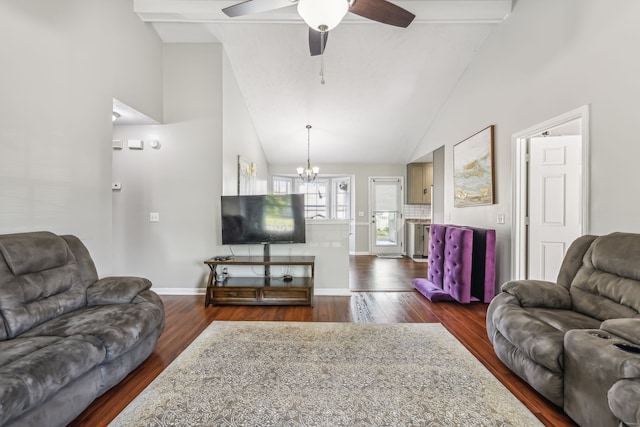 living room featuring dark wood-type flooring, ceiling fan with notable chandelier, and high vaulted ceiling