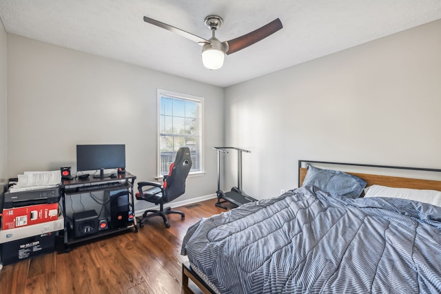 bedroom featuring dark hardwood / wood-style floors, a textured ceiling, and ceiling fan