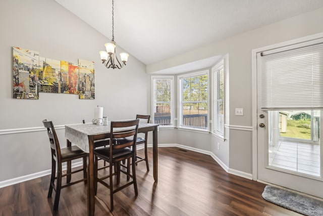 dining area featuring lofted ceiling, a notable chandelier, and dark hardwood / wood-style flooring