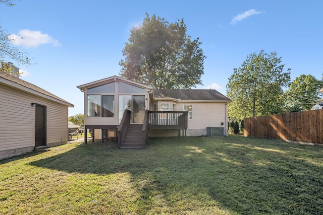 back of property featuring a yard and a sunroom