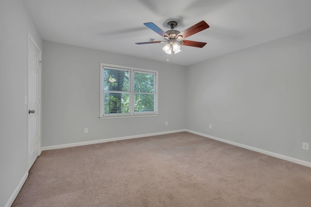 carpeted empty room featuring ceiling fan