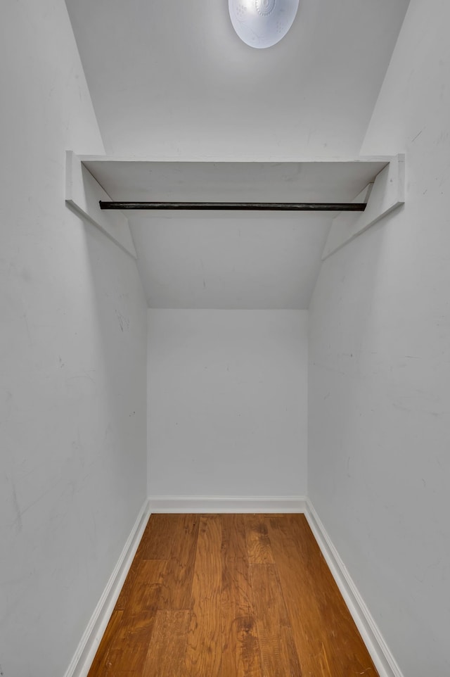 spacious closet featuring lofted ceiling and hardwood / wood-style floors