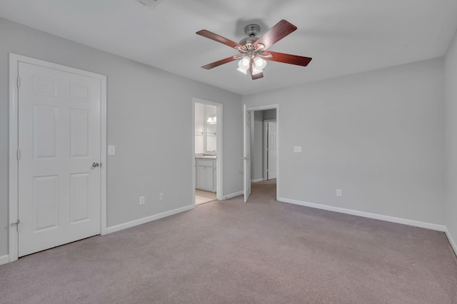 unfurnished bedroom with light carpet, ensuite bath, and ceiling fan