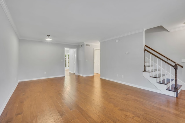 unfurnished living room with wood-type flooring and crown molding