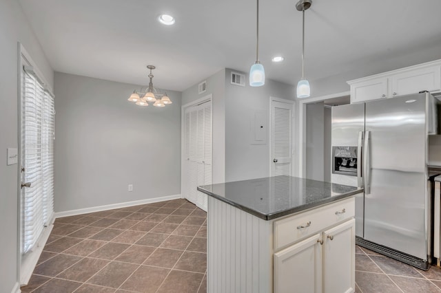 kitchen with a center island, white cabinets, hanging light fixtures, a chandelier, and stainless steel fridge with ice dispenser