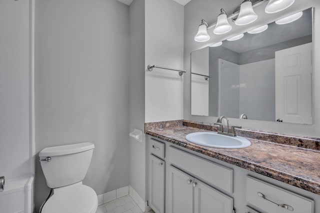 bathroom featuring tile patterned floors, vanity, and toilet