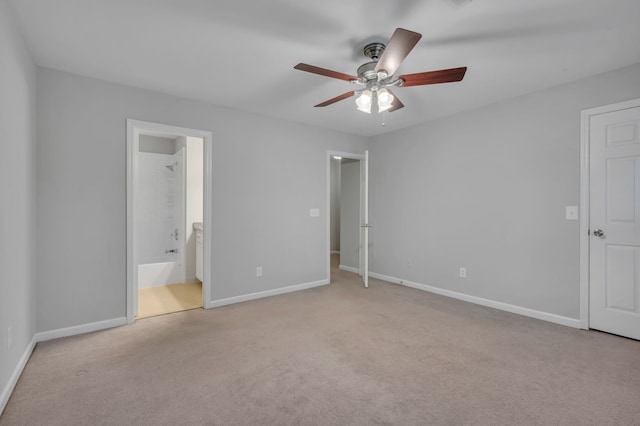 unfurnished bedroom with ceiling fan, connected bathroom, and light colored carpet