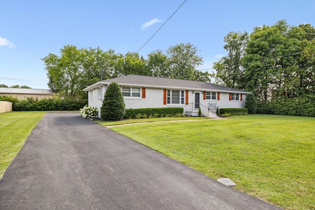 ranch-style home with a front lawn